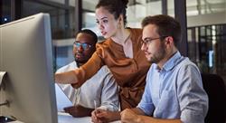 employees looking at a computer desktop