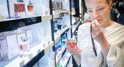 Woman smelling perfume in a retail store